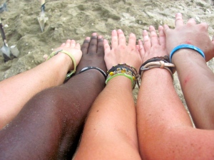 A photo of 5 arms next to eachother, all of different ethnicities. 