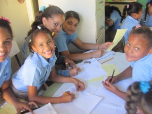 Female students smiling as they write their new friend